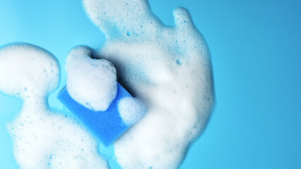 Sponge for washing dishes on blue background.