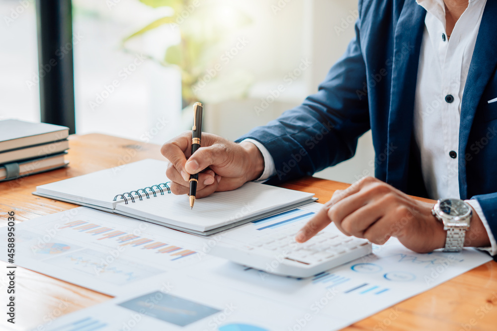 Aufkleber business man or accountant working on calculator to calculate business data concept. accounting,inve