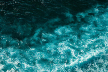 Aerial view to seething waves with foam. Waves of the sea meet each other during high tide and low tide