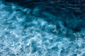 Aerial view to seething waves with foam. Waves of the sea meet each other during high tide and low tide - 458895091