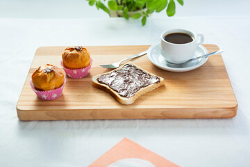 Muffins, bread chocolate and coffee for breakfast