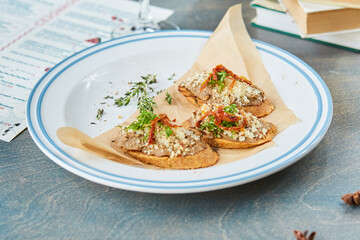bruschetta on a wooden table in a white plate