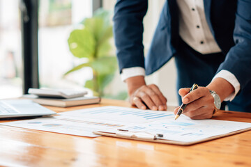Close up view of bookkeeper or financial inspector hands making report, calculating or checking...