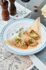 bruschetta on a wooden table in a white plate