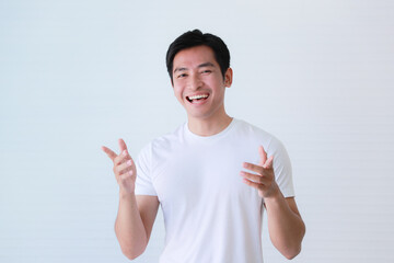 Studio portrait shot of Asian happy young handsome smart teenager teen guy male model in casual t...