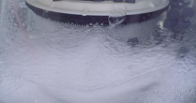 modern technology background. a stream of clean water with air bubbles passes through a transparent industrial filter for cleaning. purification and recycling of water. close-up.