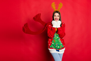 Portrait of attractive cheerful girl wearing warm clothes wind blowing eve day isolated over bright red color background