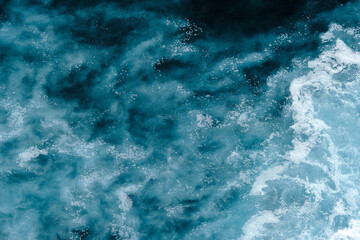 Aerial view to seething waves with foam. Waves of the sea meet each other during high tide and low tide - 458897437