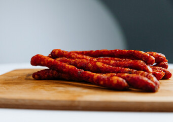 fried sausages with smoke. On a wooden board