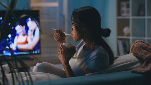 Female eating in front of TV