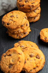 Fresh crispy chocolate cookies on a dark table