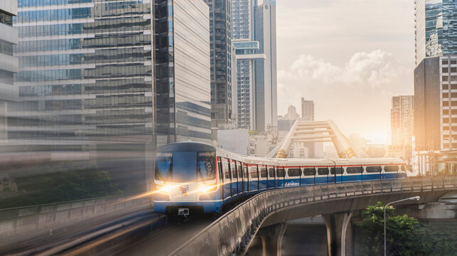 BANGKOK  THAILAND - SEP 23 : BTS Skytrain, Electric train, running on the way with business office buildings on the background on September 23,2021 in Bangkok, Thailand
