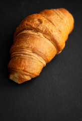 Fresh croissant on dark background