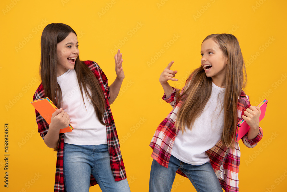 Wall mural glad happy children in casual checkered shirt with copybooks, fun