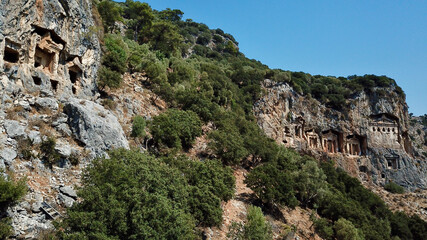 Fototapeta na wymiar King rock tombs in the ancient city of Kaunos. Dalyan near Iztuzu beach, which is the spawning area of Caretta Caretta. Caunos and Lycian ancient city.