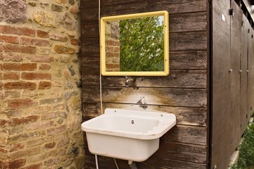 An external sink under a mirror in the garden of a farmhouse in the countryside (Umbria, Italy, Europe) - 458906023