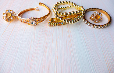 a lot of gold costume jewelry with different materials on a white background. Copy space