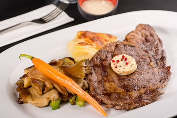 Grilled ribeye with oyster mushrooms and mashed potatoes.