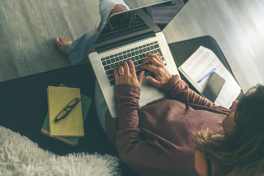 Young woman working on laptop at home. Female hands typing on pc keyboard. Teennager making an Internet video call with remote friends. Girl studying online. Technology, youth, teen, new life  concept
