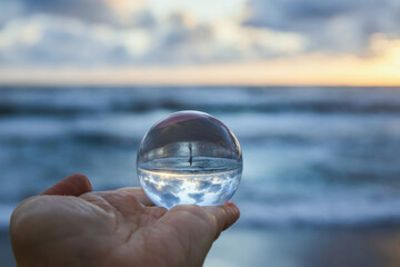 Magic sphere. Fortune teller, mind power concept. Crystal Ball reflecting water and sky.