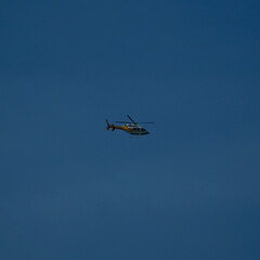 Helicopter in front of the blue sky. Helicopter flying in the air.