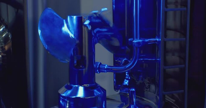 technological background.part of modern industrial equipment.the metal screw rotates slowly.close-up.