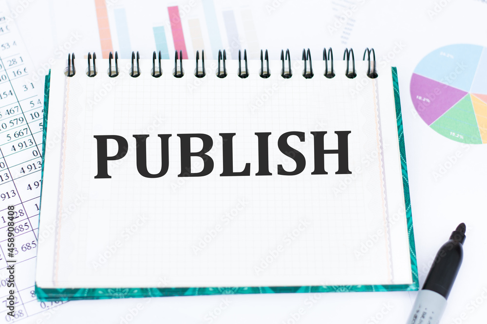 Poster on the desktop are reports and notepad with the text publish. business concept