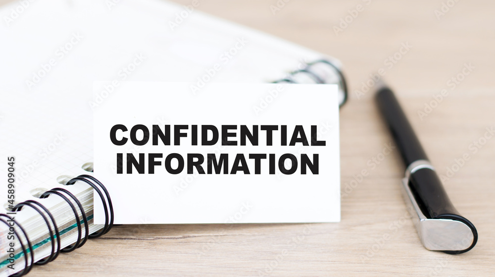 Poster business concept. card with text confidential information on the table next to a notebook and a blac