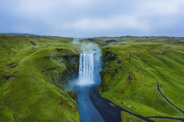 Aerial drone view of Skogafoss waterfall in Iceland, one of the most famous tourist visited attraction and landmark