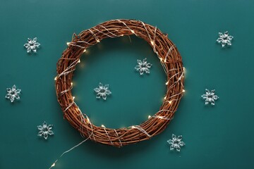 Beautiful Christmas wreath on green background, top view photography