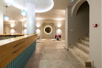 Hotel wellness center interior with mosaic tiles and wooden bench