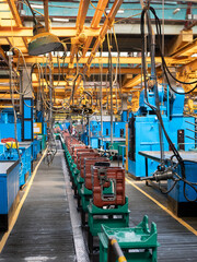 Transmission gearbox final assembly line at the tractor factory. Assembling shop interior. Tractor...
