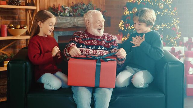 Grandpa try unpack present kids plead excited anticipation