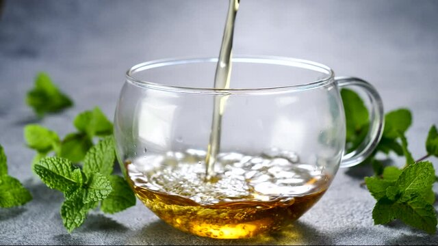 hot drink- mint tea pouring in a mug