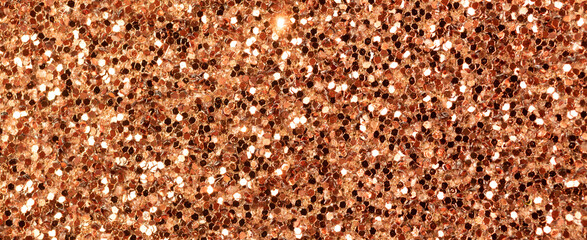 Brown glitter texture, banner macro photo, high detailed surface. Close-up to sandpapper, abstract glitter lights for holiday celebration, new year and christmas. Glowing effect concept