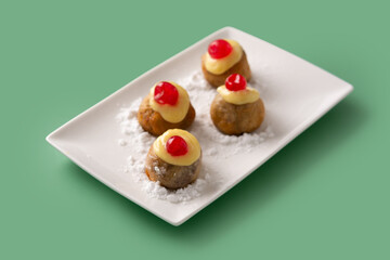 Traditional Italian Zeppole pastry on green background