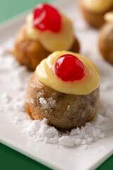 Traditional Italian Zeppole pastry on green background