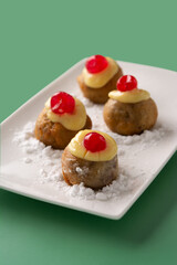 Traditional Italian Zeppole pastry on green background