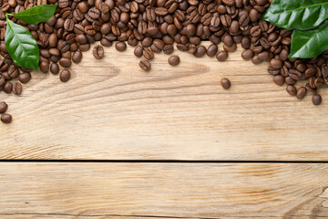 Coffee Beans With Green Leaves On Wooden