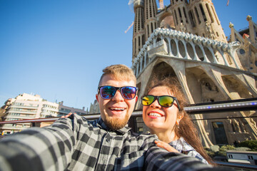 Travel, holidays and people concept - Happy couple taking selfie photo in front of the Sagrada...
