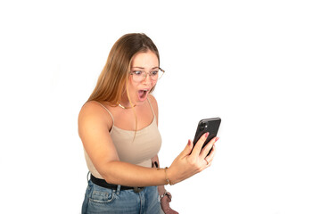 Amazed young woman looking a mobile phone. White background. 20-22 years old. White European Woman.