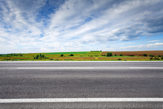 Country road with field on horizon. Side view