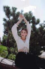 a beautiful girl in a white shirt walks in the forest, a beautiful tree, a girl near the Christmas tree, a girl model