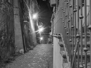 old stairs and street lighters in night shoot in Italian city