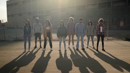 Group of activist people stand facing the camera during a protest march. Young people protesting for the protection of civil rights.