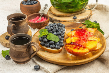 Tasty toast bread with cream cheese and ripe fruits