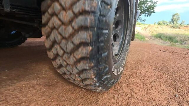 Point of view rear wheel of the light truck 4wd all wheel drive pickup running on a dirty ground off-road, adventure travel with 4x4 off road concept