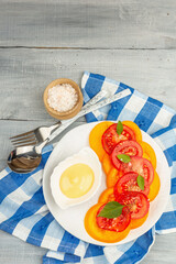 Vegan tomato salad with fresh basil leaves, spices, and delicious sauce