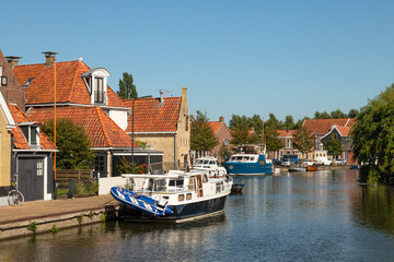 Fototapeta na wymiar Center of the small atmospheric fishing village Makkum on the Ijsselmeer in the province of Friesland.