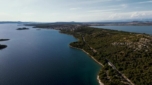 Aerial view of vehicles driving on a road along the wild coastline near Zadar, Croatia.
